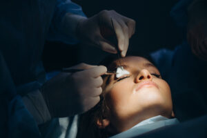 Surgeon and his assistant performing eyelids surgery 